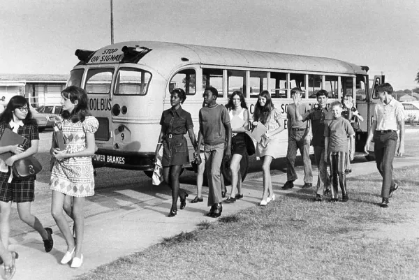 (Original Caption) 9/7/1971-Columbus, GA- Some of the estimated 10-14,000 pupils arrived at school 9/7 morning on Muscogee County school buses. The schools are open under a court-ordered desegregation plan requiring that 70 percent of the children in each school be white and 30 percent black. The district has 72 buses and each will average about three runs to travel the 231 routes tentatively to date.